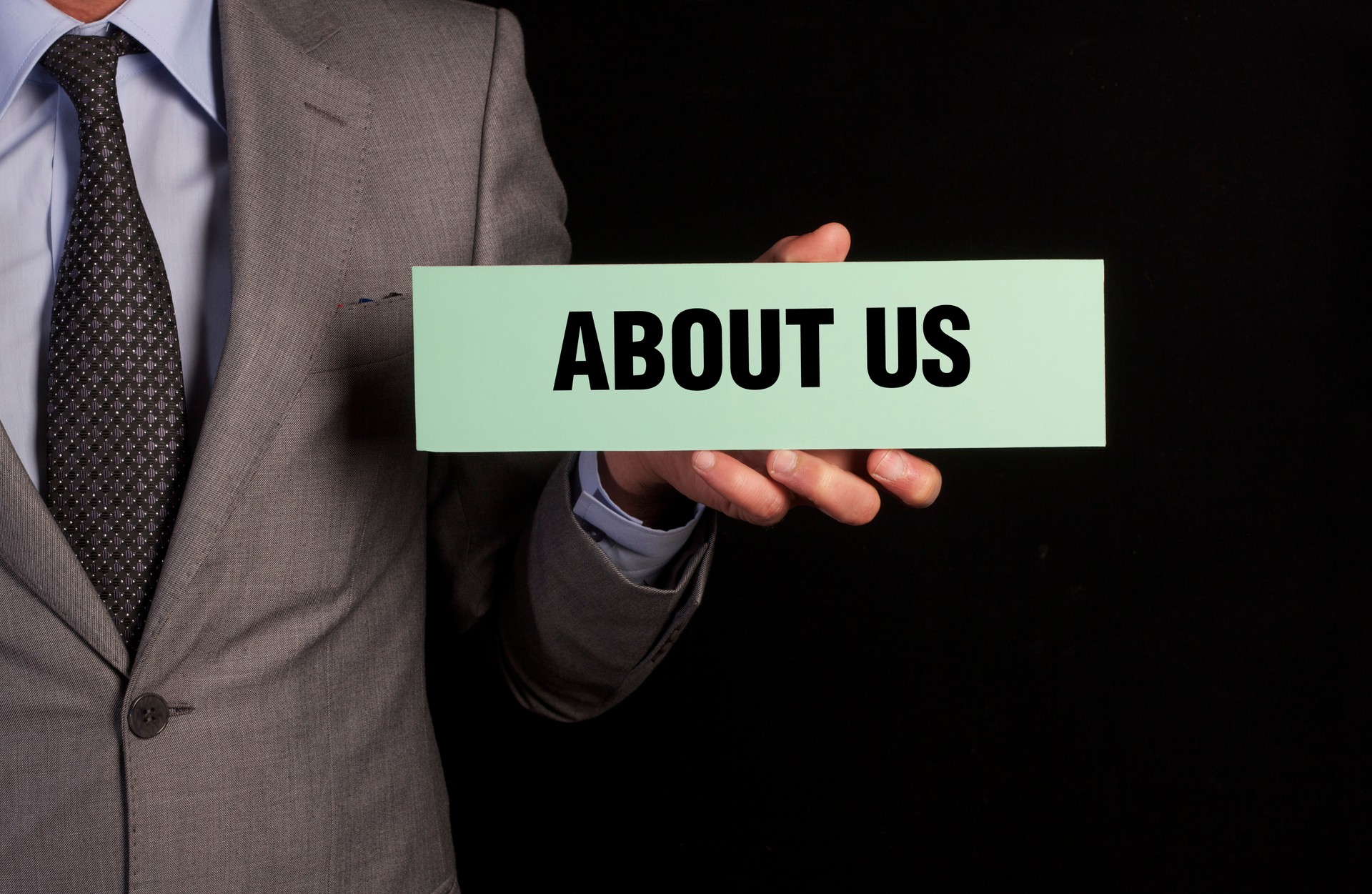 Businessman Hold Placard with About Us Message